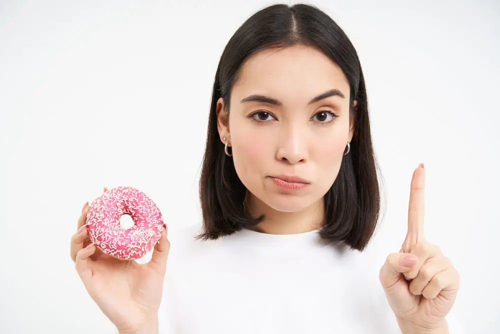 no-sweets-serious-young-woman-diet-showing-stop-gesture-glazed-doughnut-disapprove-junk-food